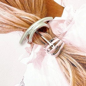 Minimalist U-shaped silver metal hair hook for low ponytail styling on blonde hair