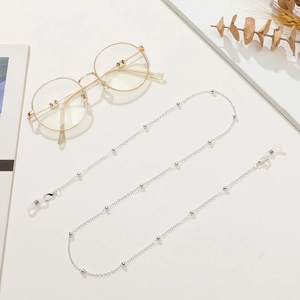 Detailed view of silver beaded eyewear chain with silicone loops and lobster clasps