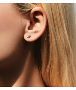 Close-up of heart-shaped moissanite stud earrings with pavé diamond halo set in S925 silver