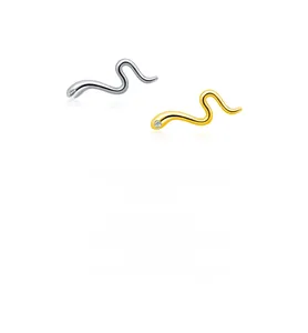Close-up of minimalist gold and silver snake stud earrings with zirconia stones