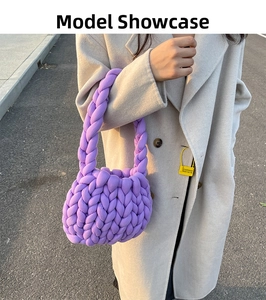 Close-up of handmade chunky purple yarn bag showing textured woven knit pattern and handle