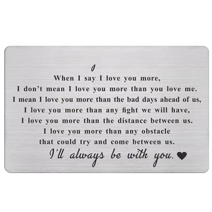 Macro shot of silver stainless steel wallet insert card with 'I love you' engraving