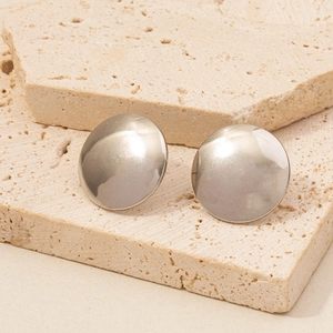 Macro detail of round 304 stainless steel stud earrings with shiny silver mirror finish