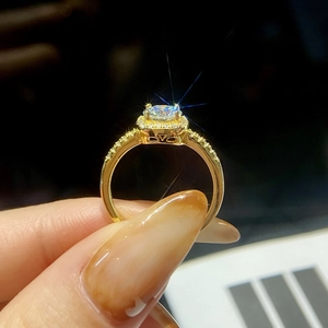 Macro detail of gold S925 silver ring featuring a square moissanite with sparkling accents