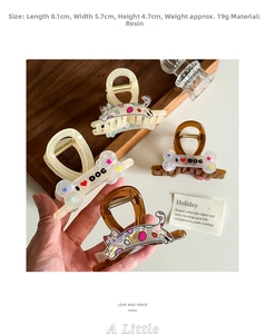 Detailed view of 8.1cm resin hair claw clips with cat patterns and bone shapes