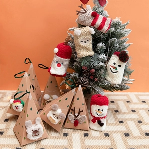 Christmas coral fleece socks with Santa and reindeer patterns in holiday gift boxes