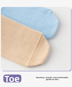 Macro detail of seamless toe construction on soft combed cotton yoga socks in blue and beige