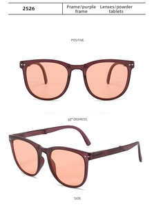 Detail view of foldable purple oval sunglasses with orange lenses and metal rivets