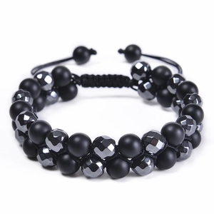 Detail of double-layer beaded bracelet with matte black beads and faceted hematite stones