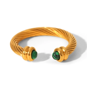 Macro detail of gold cable twisted cuff bracelet featuring green malachite stone inlays