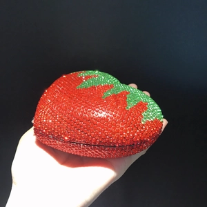 Red strawberry shaped evening clutch bag with full rhinestones and green leaf detail