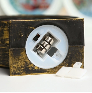 Detail view of the battery compartment and on-off switch on the Christmas LED lantern base