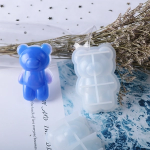 Detail of big nose bear silicone mold and blue resin bear pendant on wave background
