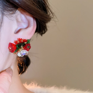 Detailed close-up of handmade floral cluster beaded earrings with crystal glass accents