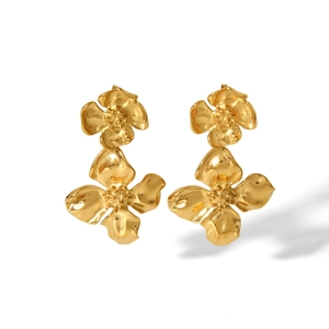 Detailed view of 18K gold floral earrings with unique hand-hammered metal texture
