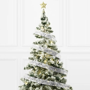Detail of silver snowflake ribbon and warm LED lights on a flocked mini Christmas tree