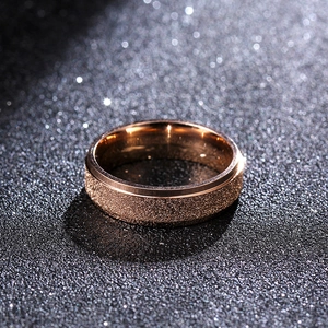 Macro shot of 6mm rose gold titanium ring with sandblasted center and polished edges