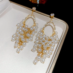 Detail of elegant grape cluster tassel earrings with pearls and zircon crystals