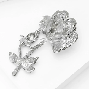 Detailed close-up showing the silver floral brooch back pin mechanism and petal textures