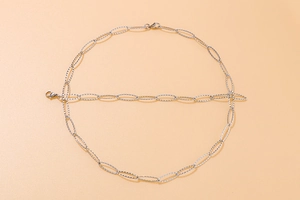 Close-up of sparkling silver stainless steel link chain necklaces with lobster clasp