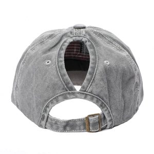 Detail of grey washed cotton ponytail baseball cap with metal buckle and oval opening