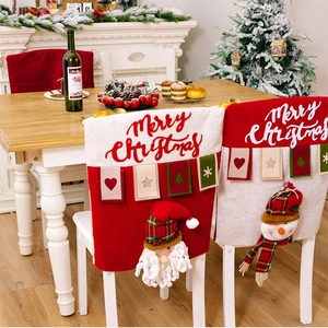 Detail of Santa and Snowman chair covers on dining chairs with festive Christmas decor