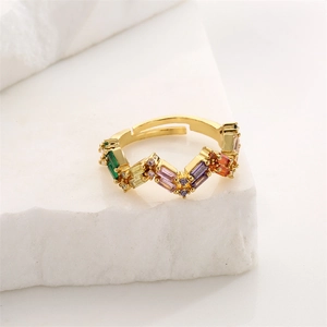 Detailed shot of gold plated ring with micro-set colorful zircons on white stone