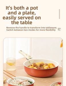 Red non-stick pan with detachable handle used as a serving dish on a wooden table
