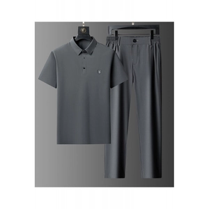 Close-up of deep gray men's ice silk polo shirt and straight trousers set on hanger