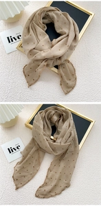 Detail of beige cotton linen scarf with brown polka dots and fine embroidered edge