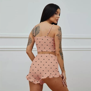 Detailed back view of pink crown print pajama set featuring ruffle hem shorts and cami top