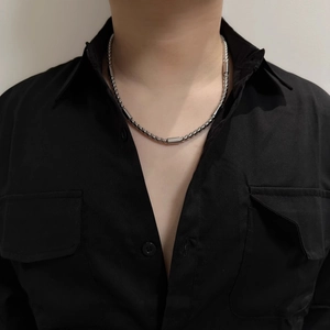 Close-up of minimalist silver stainless steel round link chain necklace worn by a model