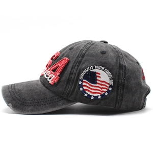 Dettaglio del cappellino in denim lavato con ricamo USA e visiera effetto consumato