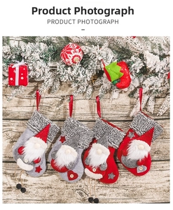 Detail view of four Christmas gnome stockings with plush cuffs on a rustic wood background