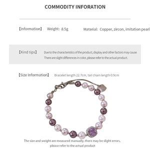 Detailed spec view of vintage pearl bracelet with square purple zircon on copper chain
