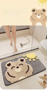 Close-up of thick absorbent flocking bath mat with a cute cartoon bear and sun design