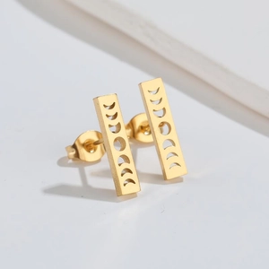 Detail of gold geometric earrings showing hollow moon phase sequence and polished surface