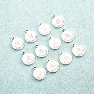 Detailed view of twelve stainless steel zodiac charms with engraved personality traits