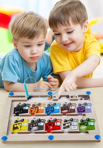 Two young boys playing with a magnetic color and number sorting wooden maze toy
