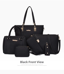 Close-up of a 6-piece black leather handbag set with white contrast stitching and gold hardware
