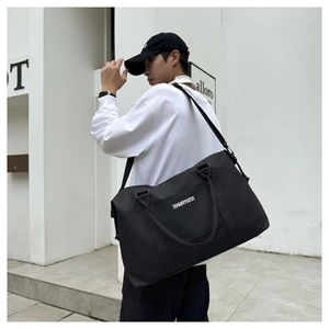 Detail of black Oxford travel bag with sturdy handles and adjustable shoulder strap