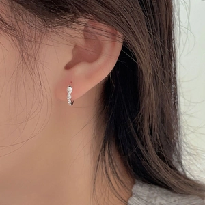 Minimalist 925 sterling silver hoop earrings featuring irregular wave texture and droplet design