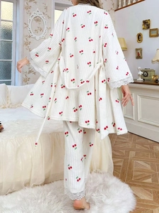 Detail of white cherry print pajama set with lace edges and soft ribbed flannel texture