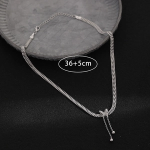 Silver Cuban chain necklace with butterfly pendant and tassel fringe details