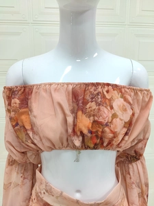Detail of off-shoulder floral chiffon top and skirt with smocked waist and rose pattern