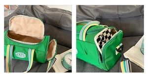 Detailed interior and side phone pocket view of green canvas dance sports duffel bag