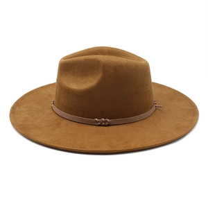 Detailed texture of brown suede fedora hat featuring a stylish narrow band with knot
