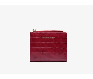 Detail of red crocodile texture small wallet with gold logo and zipper coin pocket
