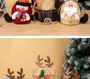 Detail of linen Christmas gift bags with Santa and reindeer plush dolls and small bells