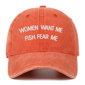 Detailed view of vintage washed cotton fabric and embroidery on orange baseball cap